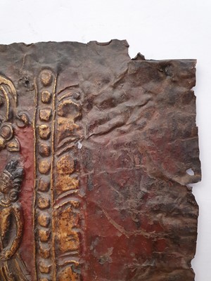 Lot 186 - A NEPALESE GILT-BRONZE PLAQUE FRAGMENT.