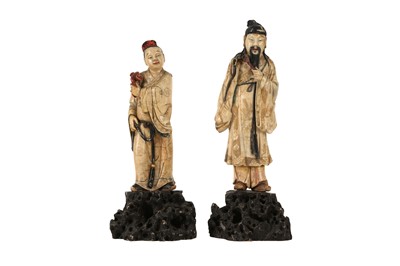 Lot 884 - TWO CHINESE STAINED AND GILT-SOAPSTONE FIGURES OF IMMORTALS.