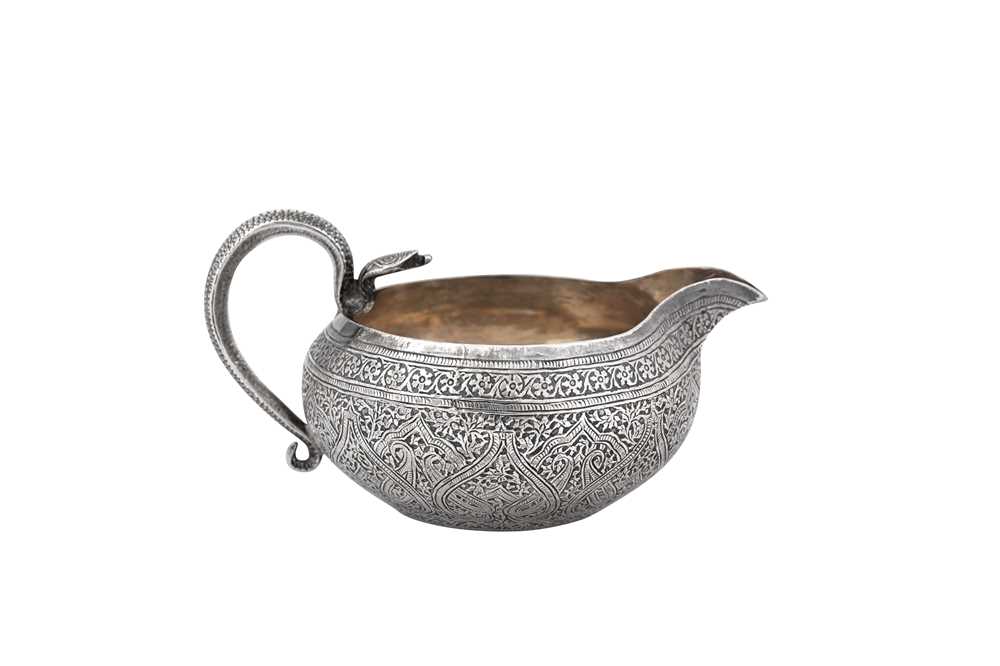 Lot 140 - A late 19th / early 20th century Anglo - Indian unmarked silver milk jug, Kashmir circa 1900