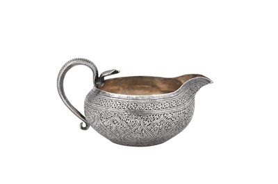 Lot 140 - A late 19th / early 20th century Anglo - Indian unmarked silver milk jug, Kashmir circa 1900