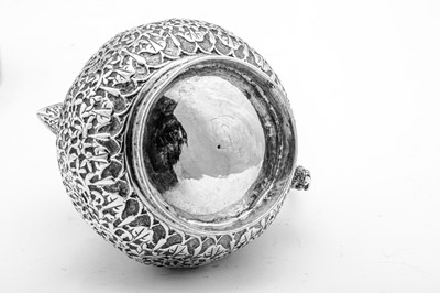 Lot 159 - A late 19th century Indian unmarked silver milk jug and sugar bowl with sugar tongs, Lucknow circa 1890