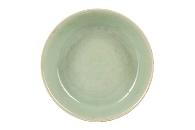 Lot 568 - A CHINESE INCISED CELADON 'DRAGONS' DISH.