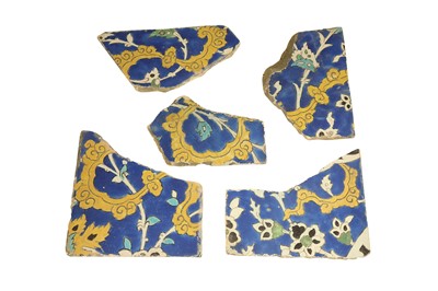 Lot 506 - FIVE FRAGMENTARY SAFAVID CUERDA SECA POTTERY TILES: THE CLOUDS