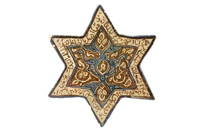 Lot 310 - AN ILKHANID COPPER LUSTRE STAR POTTERY TILE