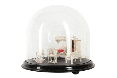 Lot 170 - A 19TH CENTURY CARVED BONE SET OF MINIATURE FURNITURE WITHIN A GLASS DOME