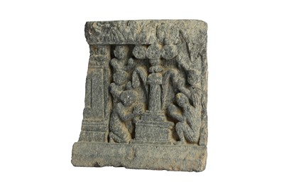 Lot 300 - A GREY SCHIST RELIEF OF WORSHIPPERS AROUND A PILLAR