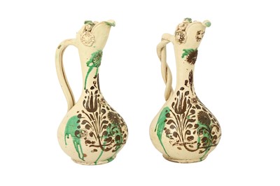 Lot 500 - A NEAR PAIR OF GREEN-SPLASHED WHITE-GLAZED CANAKKALE POTTERY EWERS