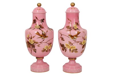 Lot 655 - A PAIR OF BACCARAT-STYLE PINK AND WHITE OPALINE GLASS LIDDED VASES PAINTED WITH GOL-O-BOLBOL MOTIF