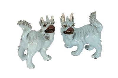 Lot 752 - A PAIR OF CHINESE PALE BLUE GLAZED MODELS OF MYTHICAL BEASTS.