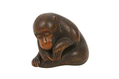 Lot 451 - A WOOD NETSUKE OF A MONKEY.