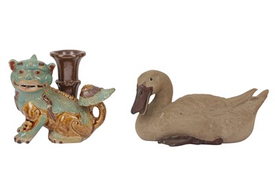 Lot 670 - A CHINESE POTTERY CANDLE STICK