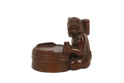Lot 453 - A WOOD NETSUKE OF A COOPER.