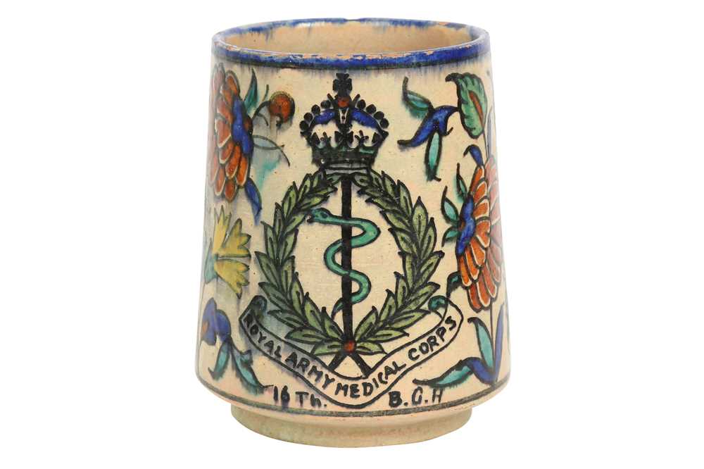 Lot 717 - A PALESTINIAN IZNIK-STYLE POTTERY MUG WITH THE BRITISH ROYAL ARMY MEDICAL CORPS EMBLEM