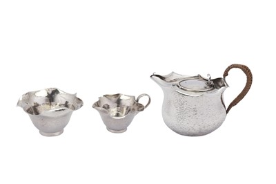 Lot 330 - A Victorian ‘Arts and Crafts’ sterling silver three-piece bachelor tea set, London 1883/84 by Hukin and Heath