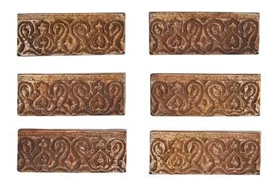 Lot 354 - SIX QAJAR COPPER LUSTRE-PAINTED POTTERY BORDER TILES