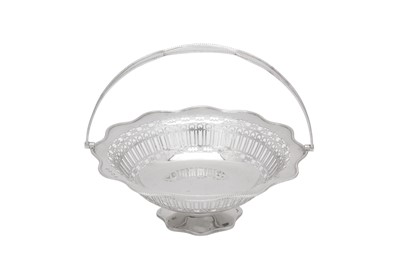 Lot 365 - A George V sterling silver cake basket, Sheffield 1922 by William Hutton and Son