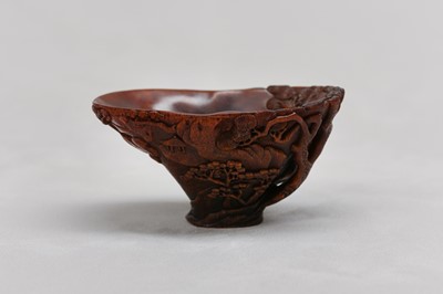 Lot 34 - A CHINESE RHINOCEROS HORN ‘RIVER LANDSCAPE’ LIBATION CUP.