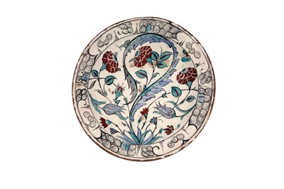 Lot 312 - AN IZNIK POTTERY DISH WITH SAZ LEAF