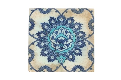 Lot 320 - A BLUE AND WHITE IZNIK POTTERY TILE WITH STYLISED LOTUS BLOSSOM