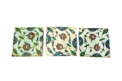 Lot 324 - THREE IZNIK POTTERY TILES WITH POMEGRANATE FLOWERS