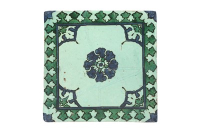 Lot 335 - AN IZNIK GREEN AND BLUE 'KA'BA-STYLE' POTTERY TILE