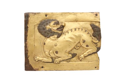 Lot 420 - A TIBETAN GILT-COPPER REPOUSSE 'SNOW LION' PLAQUE.
