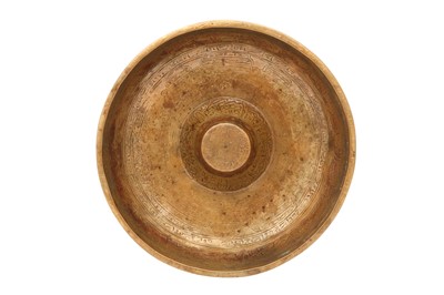 Lot 222 - A BRASS MAGIC BOWL WITH PSEUDO-SYRIAC INSCRIPTIONS