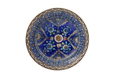Lot 419 - A QAJAR POLYCHROME-PAINTED POTTERY DISH