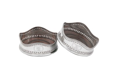 Lot 487 - A pair of George III Irish sterling silver wine coasters, Dublin 1790-91 by Christopher Haines