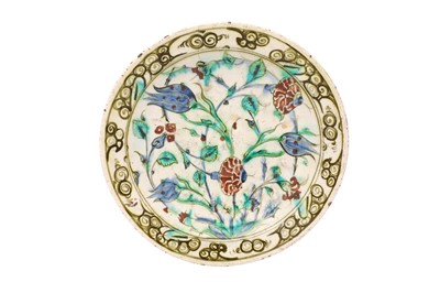 Lot 316 - AN IZNIK POTTERY DISH WITH TULIPS AND CARNATIONS