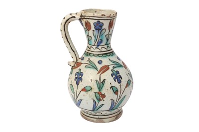 Lot 317 - A SMALL IZNIK POTTERY JUG WITH FLORAL MOTIF