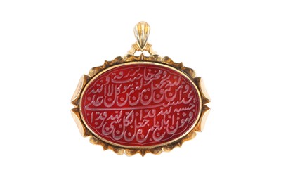 Lot 540 - A RED CARNELIAN NASTA'LIQ INTAGLIO PENDANT IN GILT SILVER BACKING