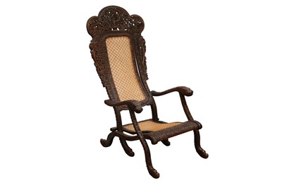 Lot 395 - AN ANGLO-INDIAN CARVED HARDWOOD FOLDING CHAIR