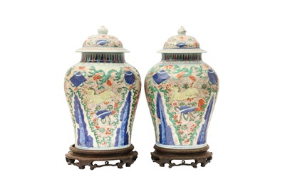Lot 225 - A NEAR-PAIR OF CHINESE WUCAI BALUSTER 'HORSES' VASES AND COVERS.