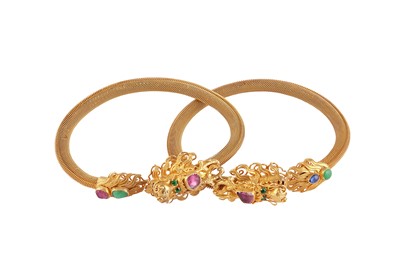 Lot 123 - A set of two gem-set torc bangles