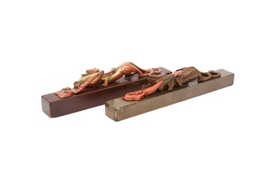 Lot 281 - TWO CHINESE RED AND BROWN FUJIANESE LACQUER SCROLL WEIGHTS.