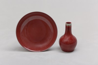 Lot 80 - A CHINESE COPPER RED-GLAZED BOTTLE VASE AND DISH.