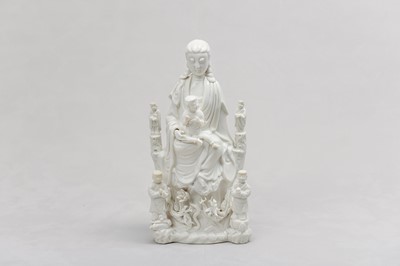 Lot 26 - A CHINESE BLANC-DE-CHINE 'GUANYIN AND CHILD' GROUP.