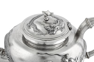 Lot 235 - An early 20th century Chinese Export silver three-piece tea service on a twin handled tray, Shanghai dated 1926 retailed by Zee Woo