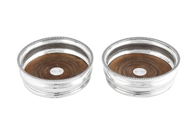 Lot 565 - A pair of George III Scottish sterling silver wine coasters, Edinburgh 1810 by Robert Gray and Sons of Glasgow