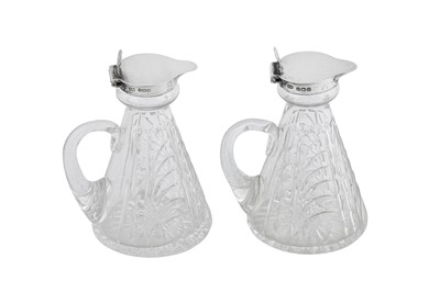 Lot 45 - A closely matched pair of George VI sterling silver mounted glass whiskey noggins, Birmingham 1937/38 Hukin and Heath