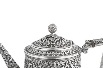 Lot 141 - A rare documentary late 19th century Anglo – Indian silver three-piece tea service, Cutch, Bhuj circa 1880 by Oomersi Mawji (active 1860-90)