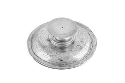 Lot 692 - An Elizabeth I sterling silver communion cup cover (paten), London 1569, makers mark a millrind in a shaped cartouche (unidentified)