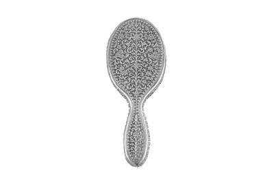 Lot 129 - An early 20th century Anglo - Indian unmarked silver hand mirror, Cutch circa 1910