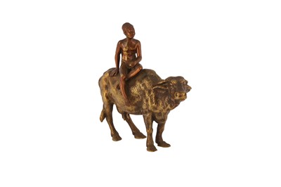 Lot 679 - A GILT BRONZE FIGURE OF A YOUNG BOY RIDING A BUFFALO