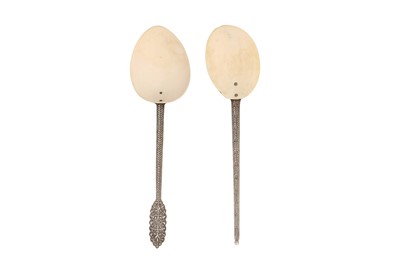 Lot 707 - TWO SINHALESE SERVING SHELL SPOONS WITH SILVER HANDLES