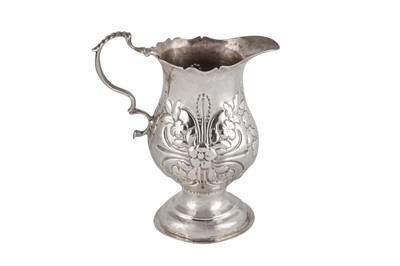 Lot 1 - A GEORGE III STERLING SILVER CREAM OR MILK JUG, LONDON 1774 BY THOMAS ELLIS