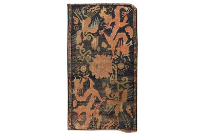 Lot 43 - AN ANTIQUE TIBETAN RUG