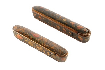 Lot 35 - TWO LACQUERED PAPIER-MÂCHÉ PEN CASES (QALAMDAN) WITH GOL-O-BOLBOL MOTIFS