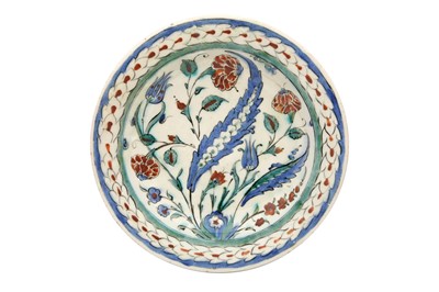Lot 497 - AN IZNIK POTTERY DISH WITH SAZ LEAF